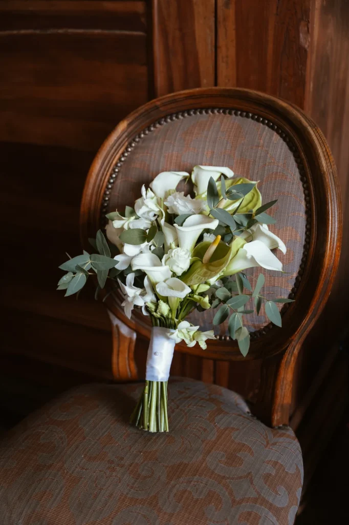 Il bouquet di calle bianche appoggiato su una sedia antica