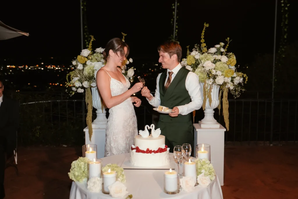 Gli sposi tagliano la torta nella sera sulle colline