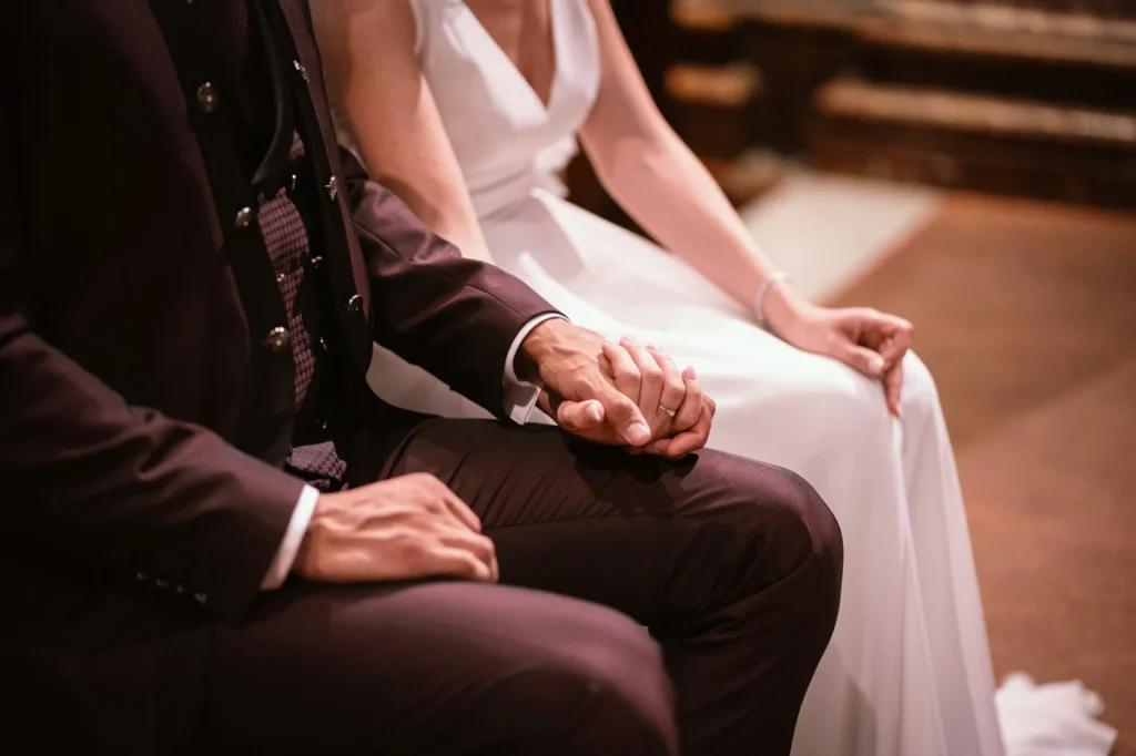 Le mani degli sposi seduti durante il rito